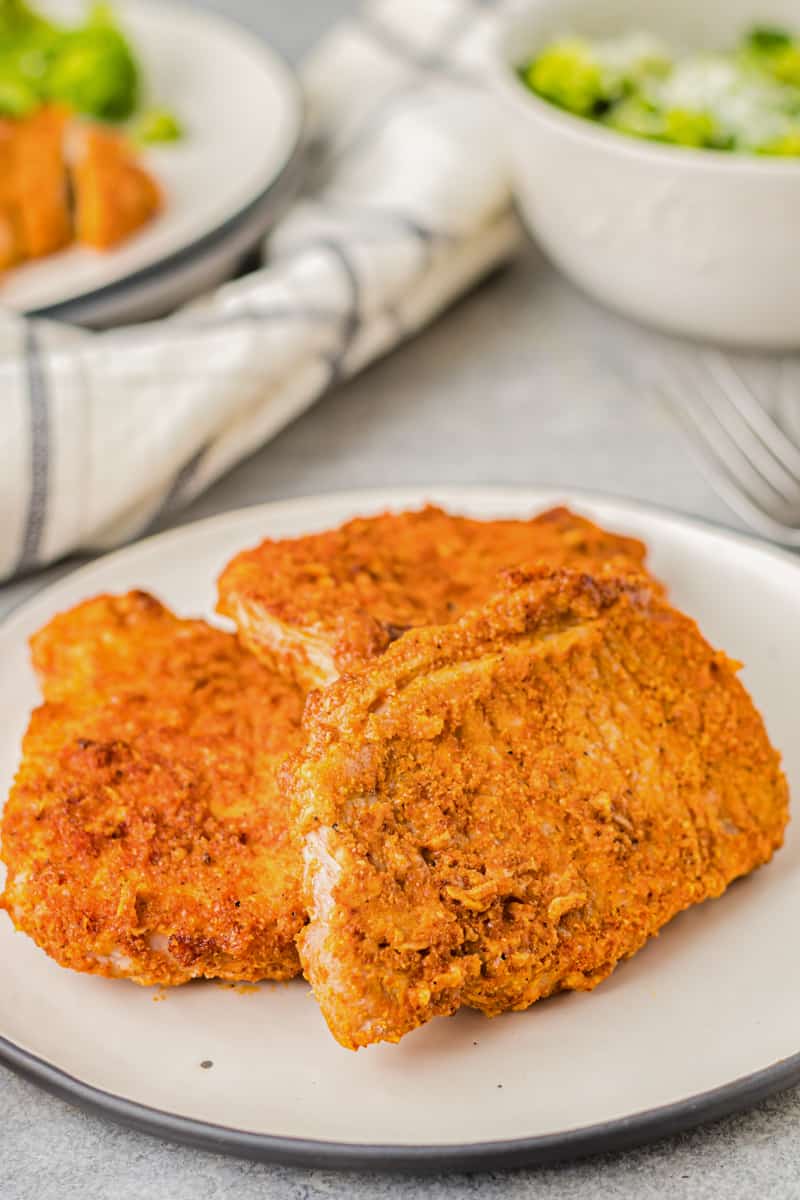 cooked pork chops on a white plate