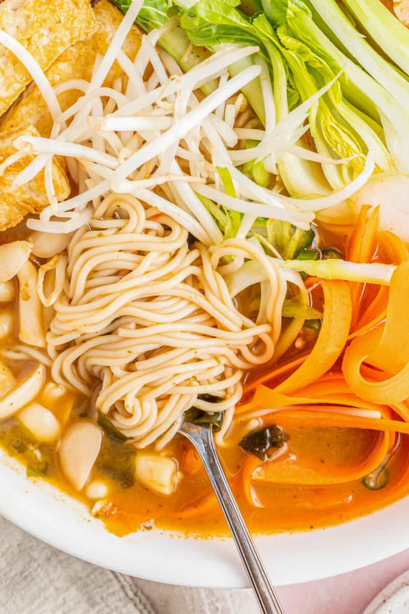 close up of easy ramen in a white bowl with a spoon.