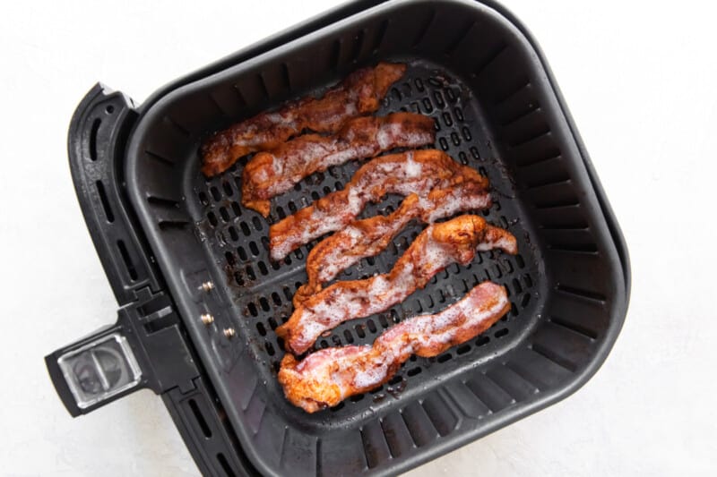 slices of bacon in an air fryer after cooking