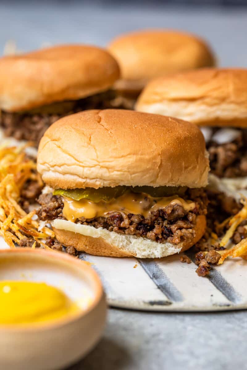 maid rite sandwiches topped with cheese and pickles