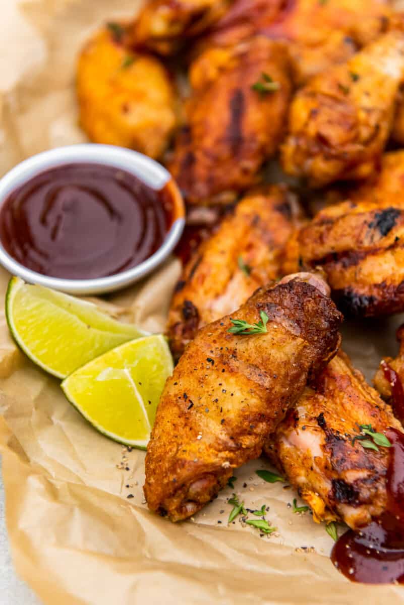 grilled chicken wings with dipping sauce in a small bowl
