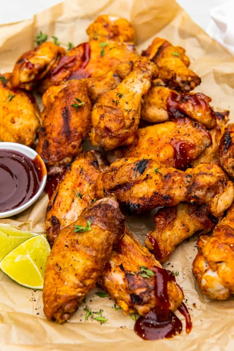 grilled chicken wings with dipping sauce in a small bowl