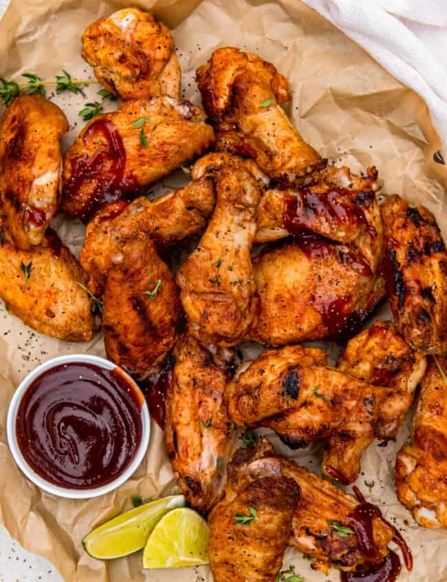 grilled chicken wings with dipping sauce in a small bowl