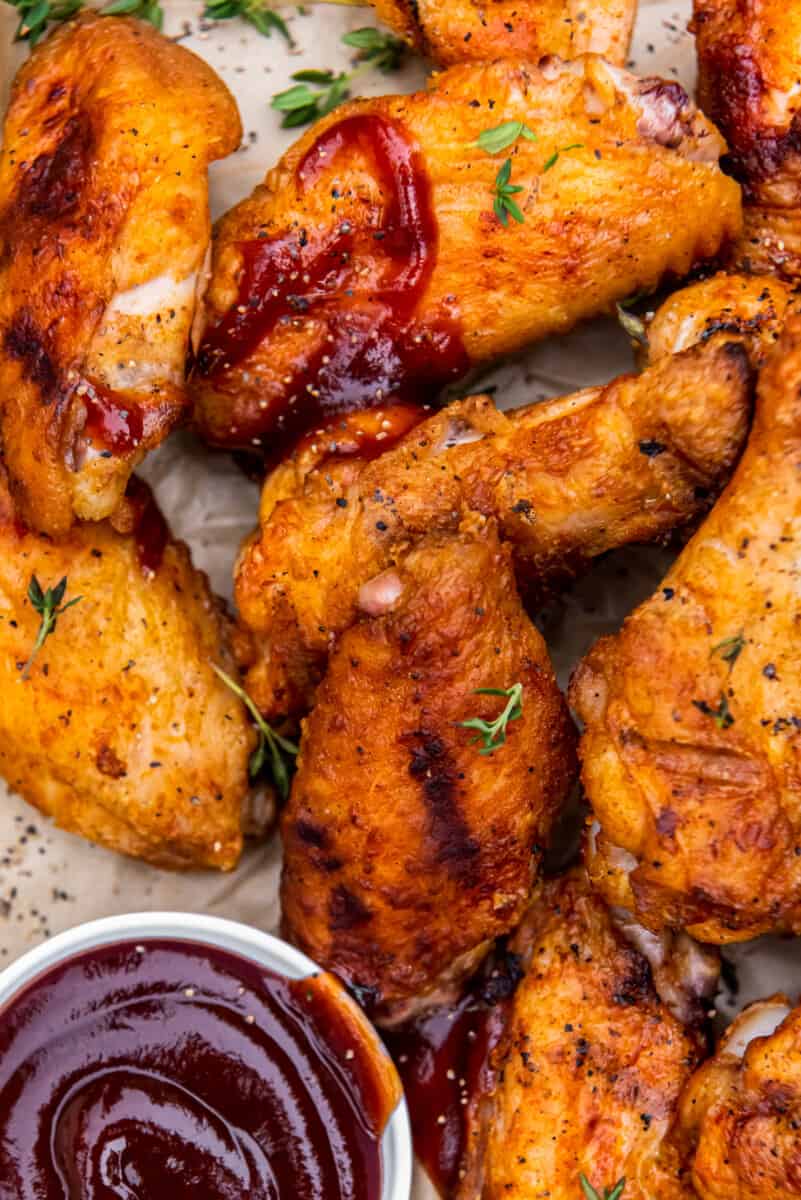 grilled chicken wings with dipping sauce in a small bowl