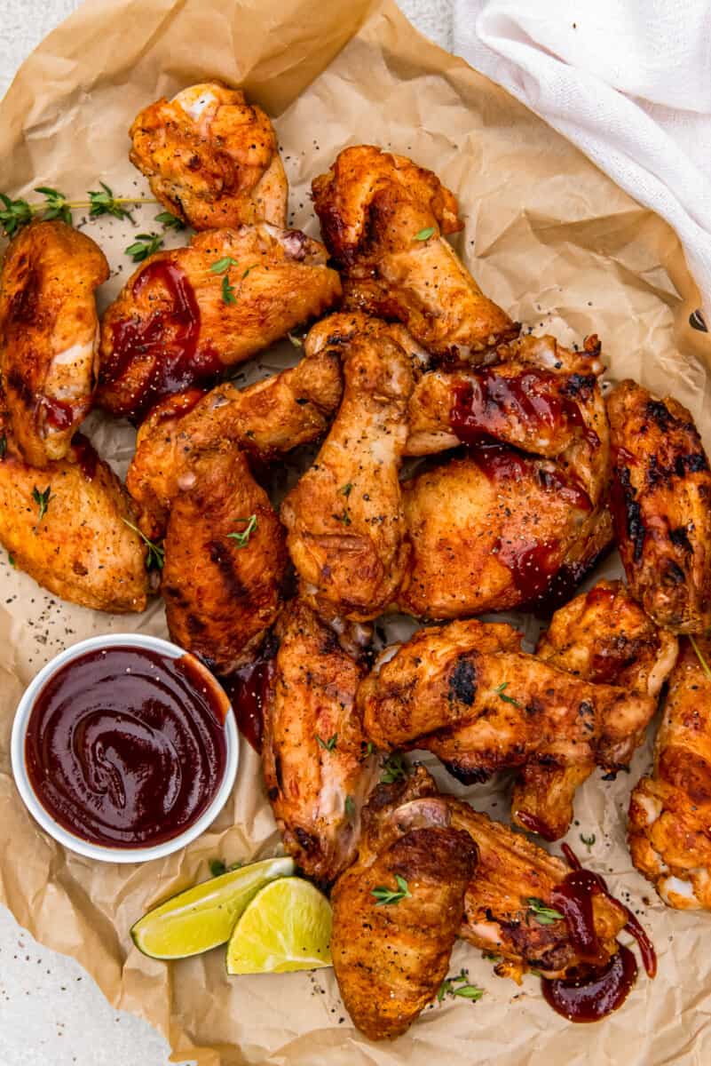 grilled chicken wings with dipping sauce in a small bowl