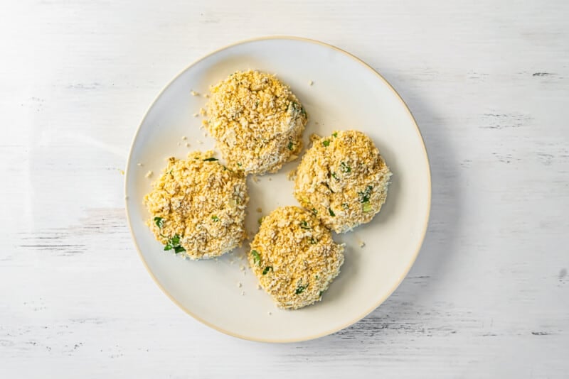 4 crab cakes on a white plate