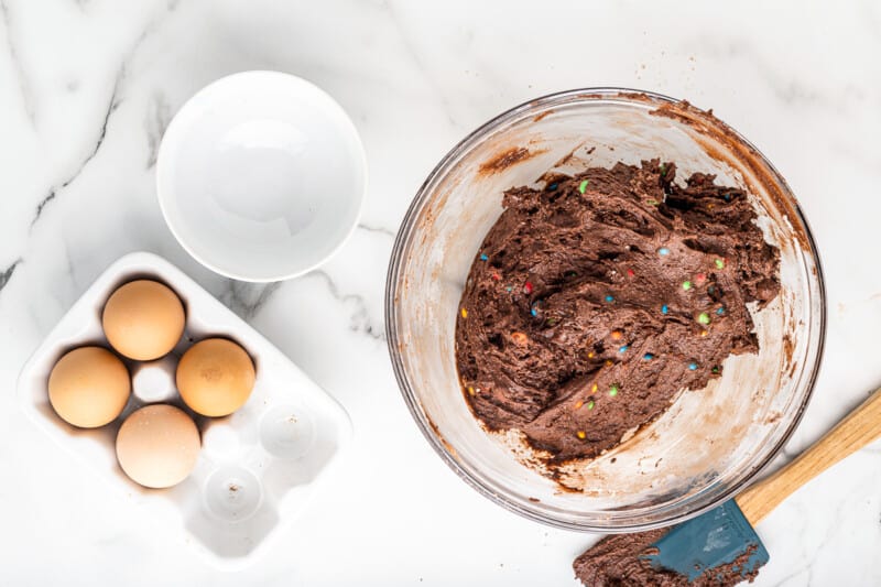 M&M brownie cookie dough in a glass bowl