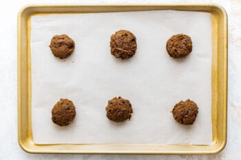 mocha cookie dough balls on a parchment paper lined baking sheet