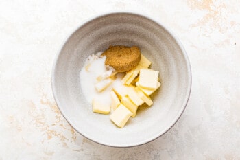 butter, granulated sugar, and brown sugar in a white bowl