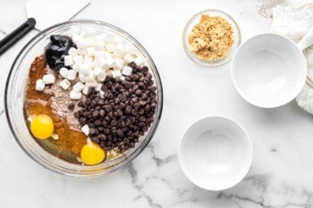 ingredients in a glass bowl for smore brownie cookies