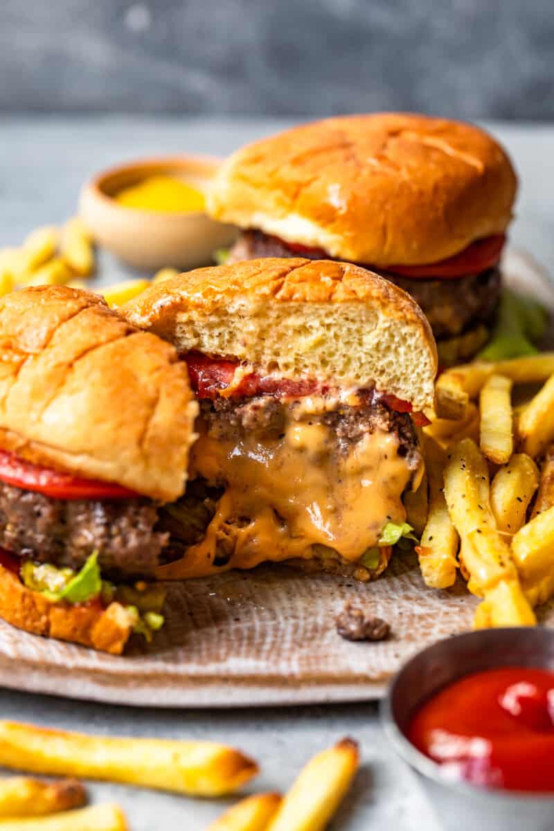 cheese stuffed burger cut in half on a plate showing the melted cheese filling