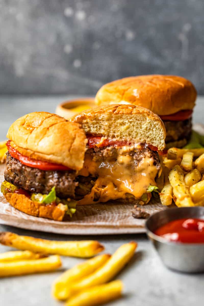 cheese stuffed burger cut in half on a plate showing the melted cheese filling