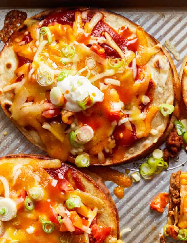 two beef mexican pizzas on baking sheet