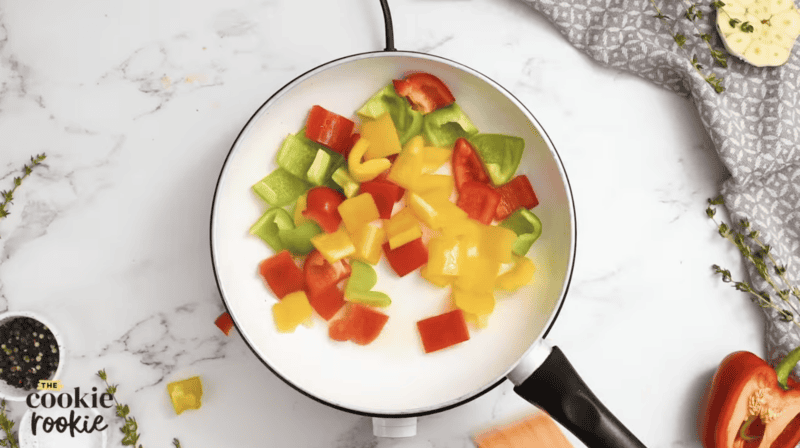 large chunks of bell peppers in a sautepan.