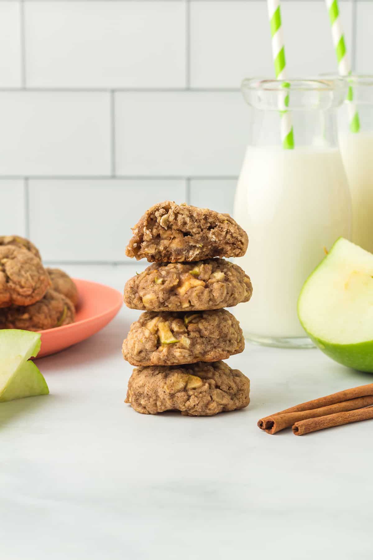 stack of 4 apple cinnamon breakfast cookies with a bite taken out of the top one