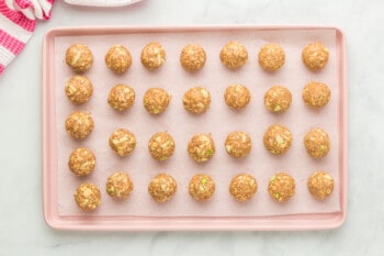 apple cinnamon breakfast cookie dough balls on a parchment paper lined baking sheet