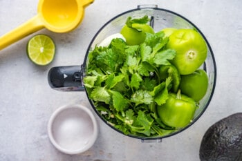 ingredients for tomatillo avocado salsa in a food processor