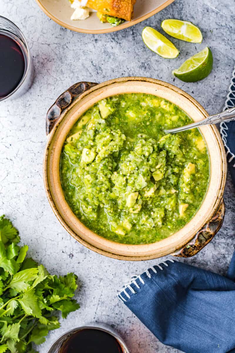 tomatillo avocado salsa in a bowl with a spoon