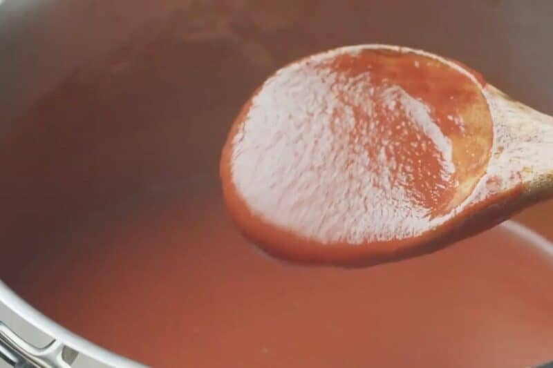 cooked for 30 min. Close up of a spoonful taco sauce.
