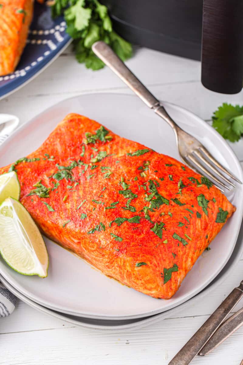 cilantro lime salmon on a white plate with a fork