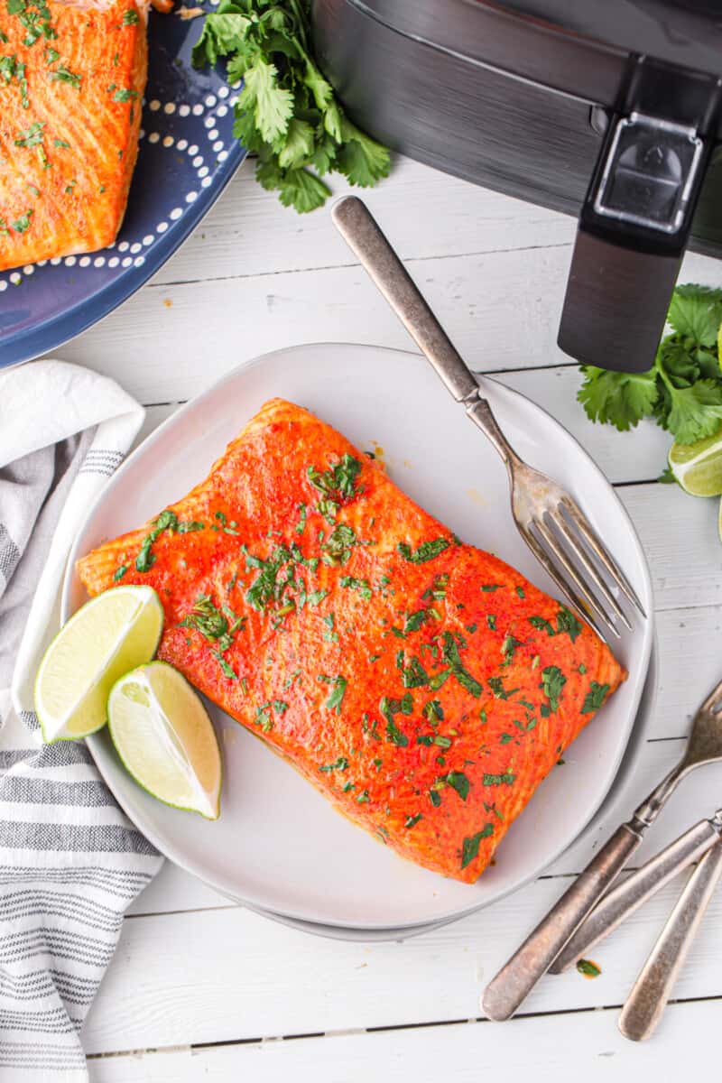 overhead image of cilantro lime salmon on a white plate with a fork