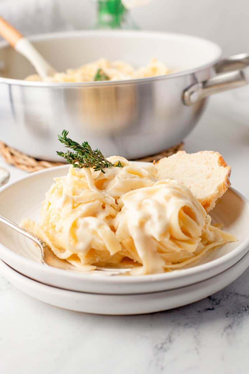 fettuccine Alfredo on a white plate with a fork