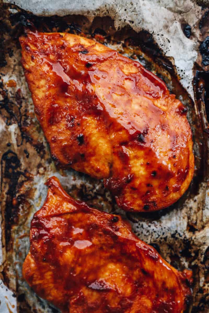 baked bbq chicken breasts on parchment paper