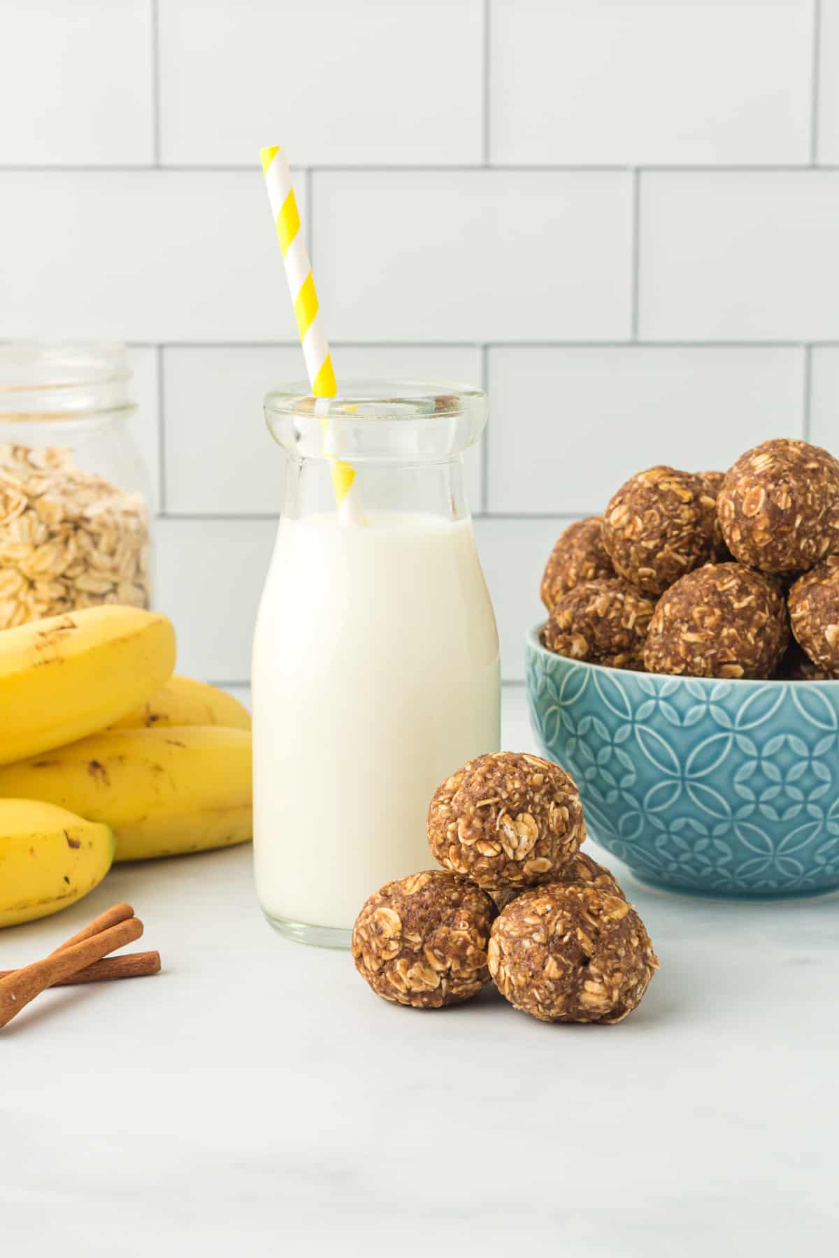 banana bread protein balls with a glass of milk with a straw