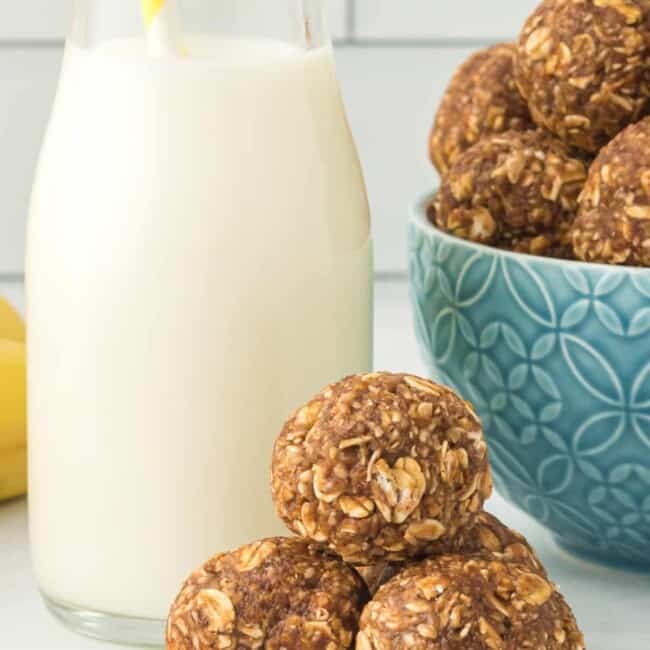 banana bread protein balls with a glass of milk with a straw