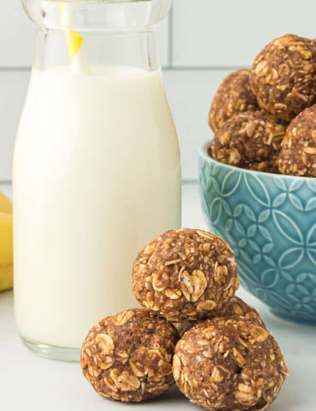 banana bread protein balls with a glass of milk with a straw