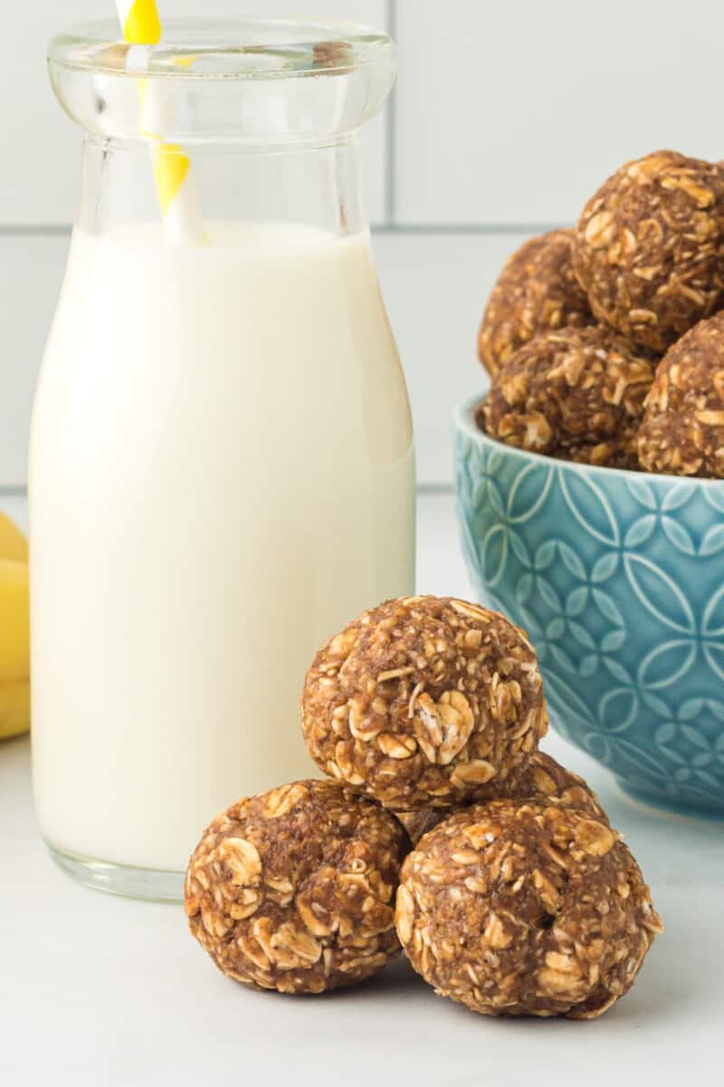 banana bread protein balls with a glass of milk with a straw