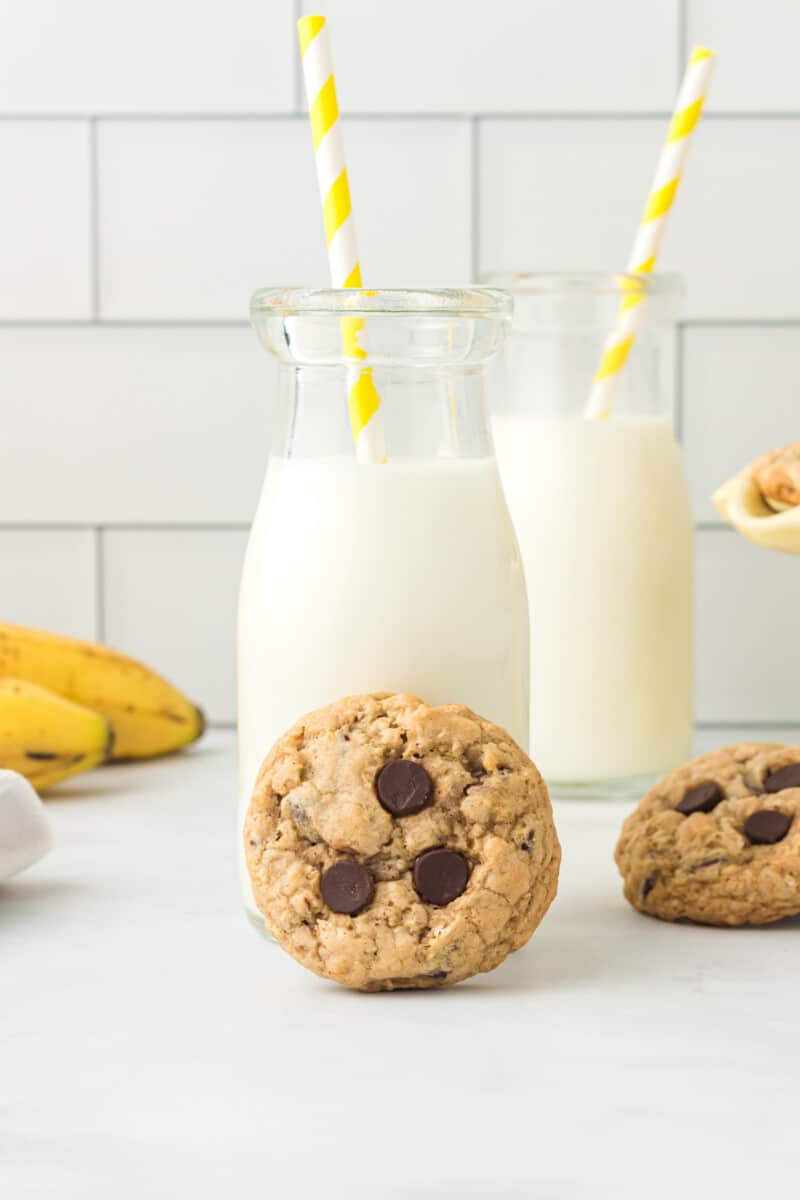 banana breakfast cookie with a glass of milk with a straw