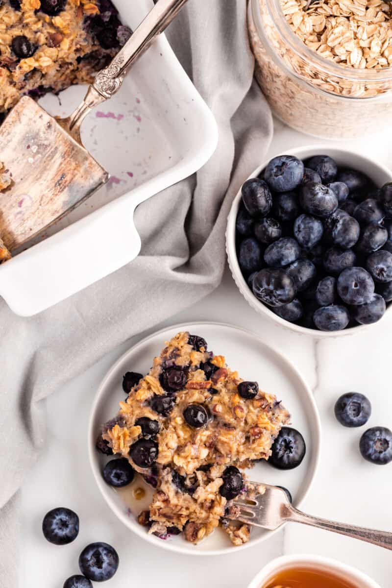 slice of blueberry baked oatmeal on a white plate with a fork