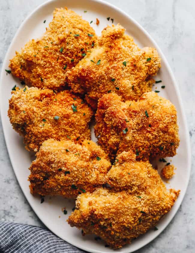 baked chicken thighs on a white serving plate