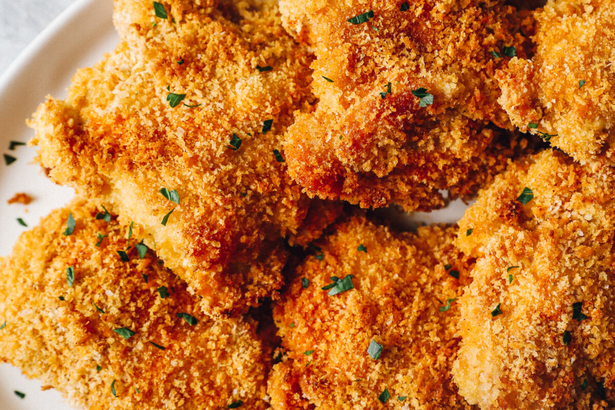 baked chicken thighs on a white serving plate