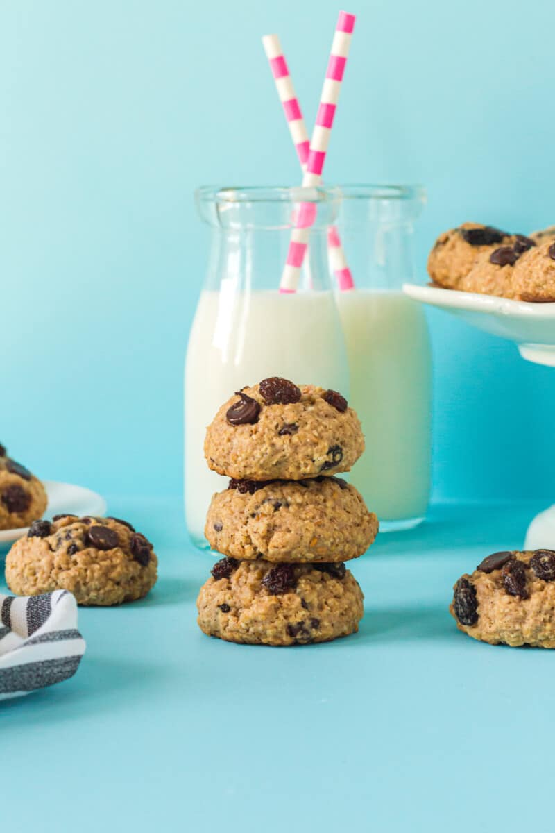 stack of 3 chocolate chip breakfast cookies with a glass of milk with a straw
