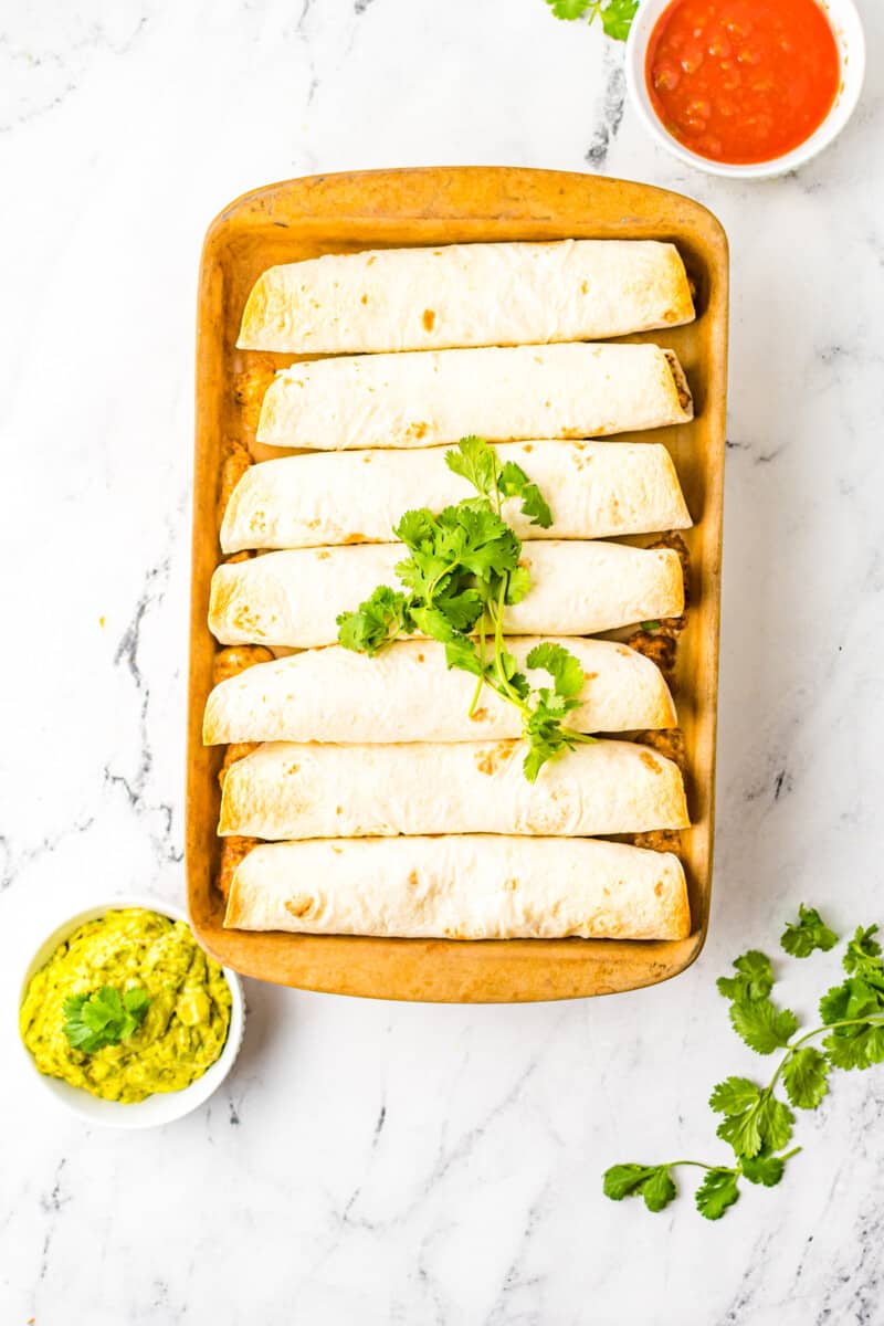 beef taquitos on a baking sheet after baking