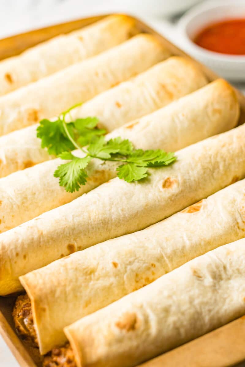 beef taquitos on a baking sheet after baking