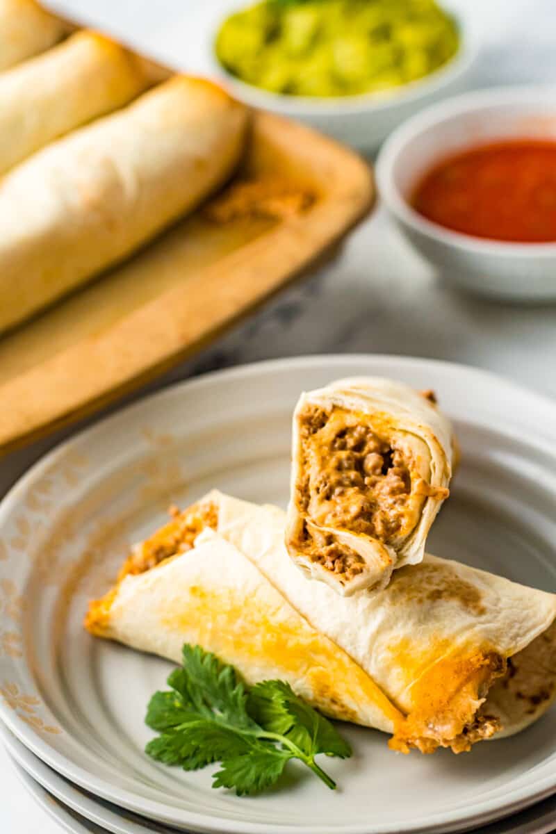 beef taquito on a gray plate with a bite taken from it