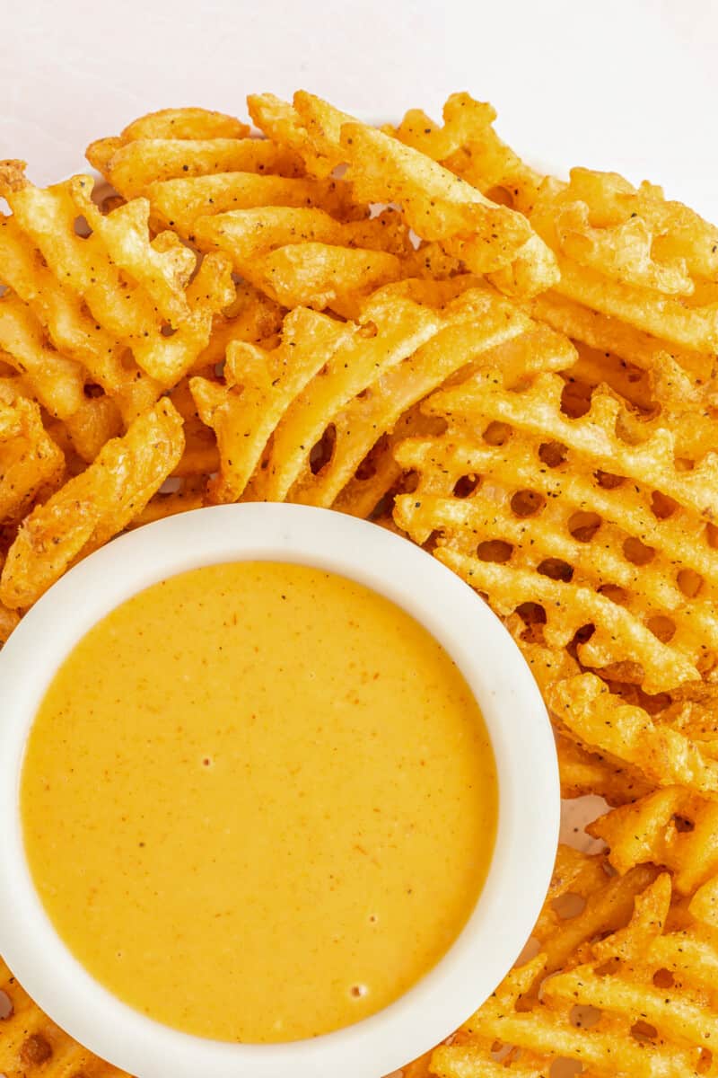 chick-fil-a sauce in a white bowl on a serving platter with waffle fries