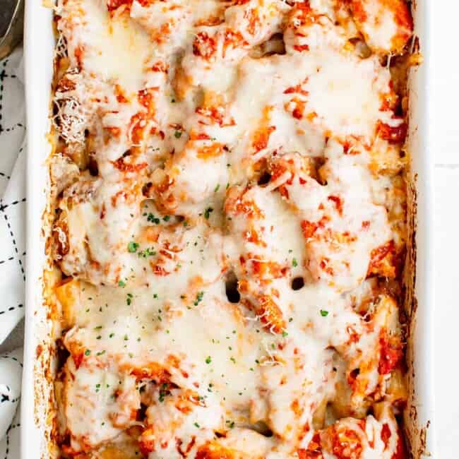 overhead image of chicken parmesan casserole in a white baking dish