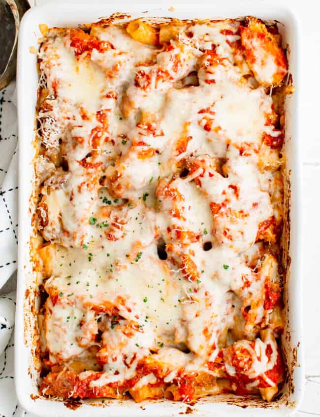 overhead image of chicken parmesan casserole in a white baking dish