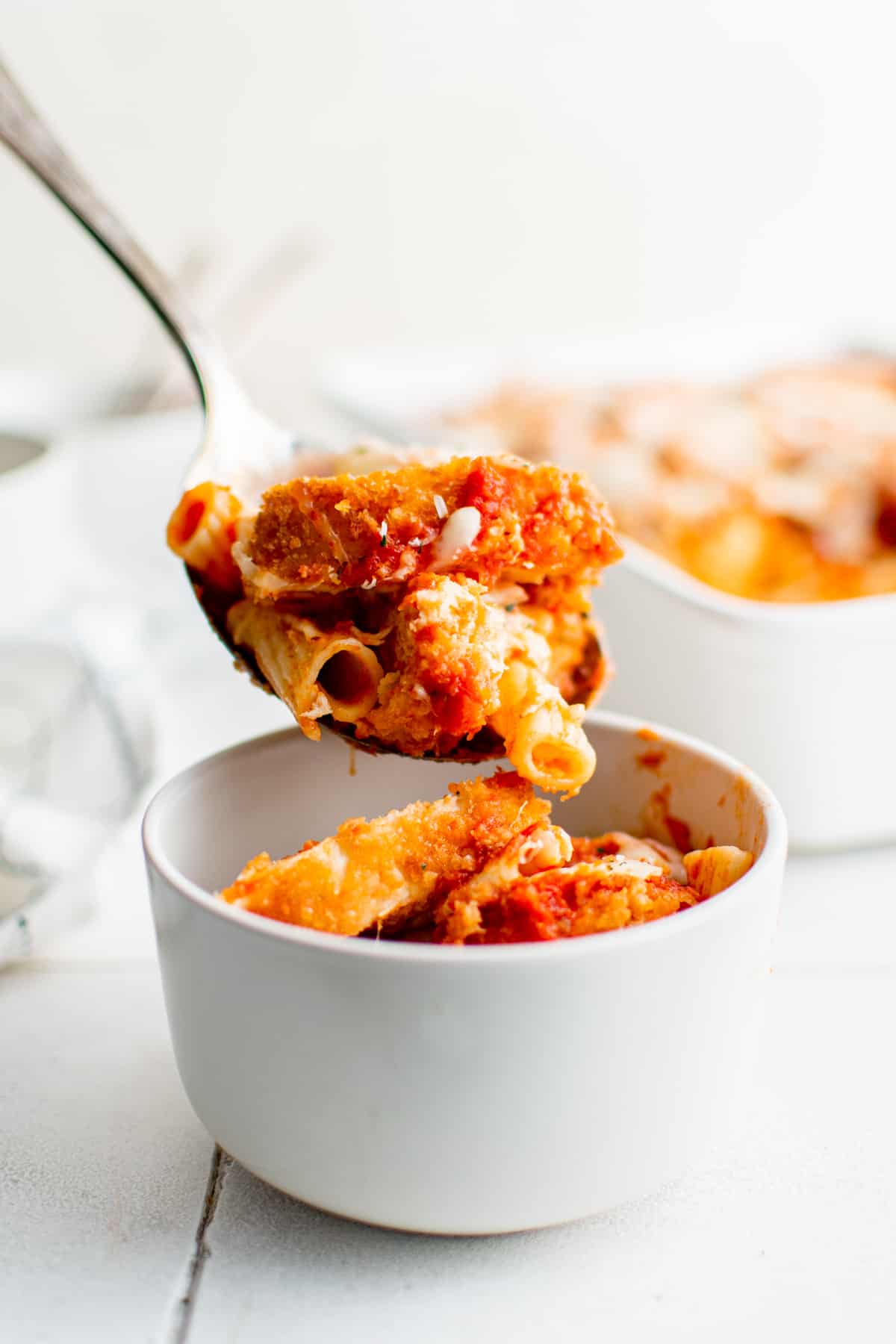 serving spoon of chicken parmesan casserole