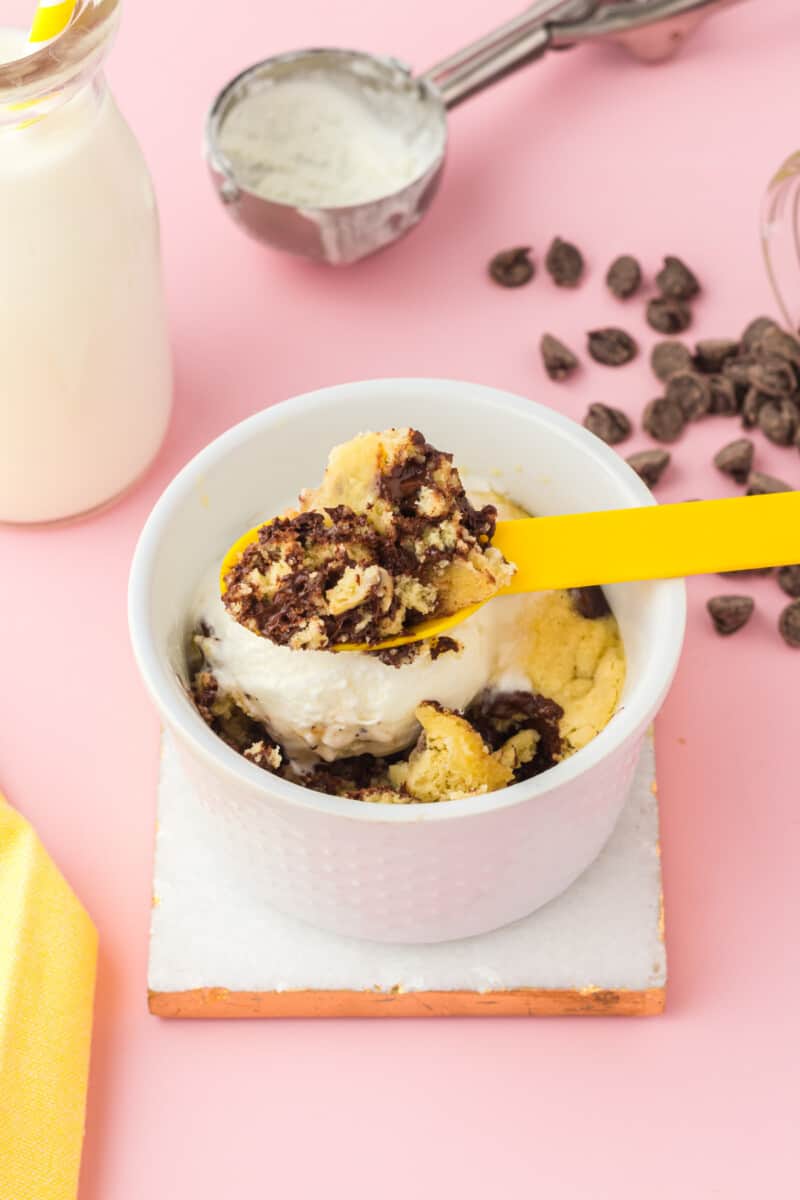 yellow spoon of chocolate chip mug cookie