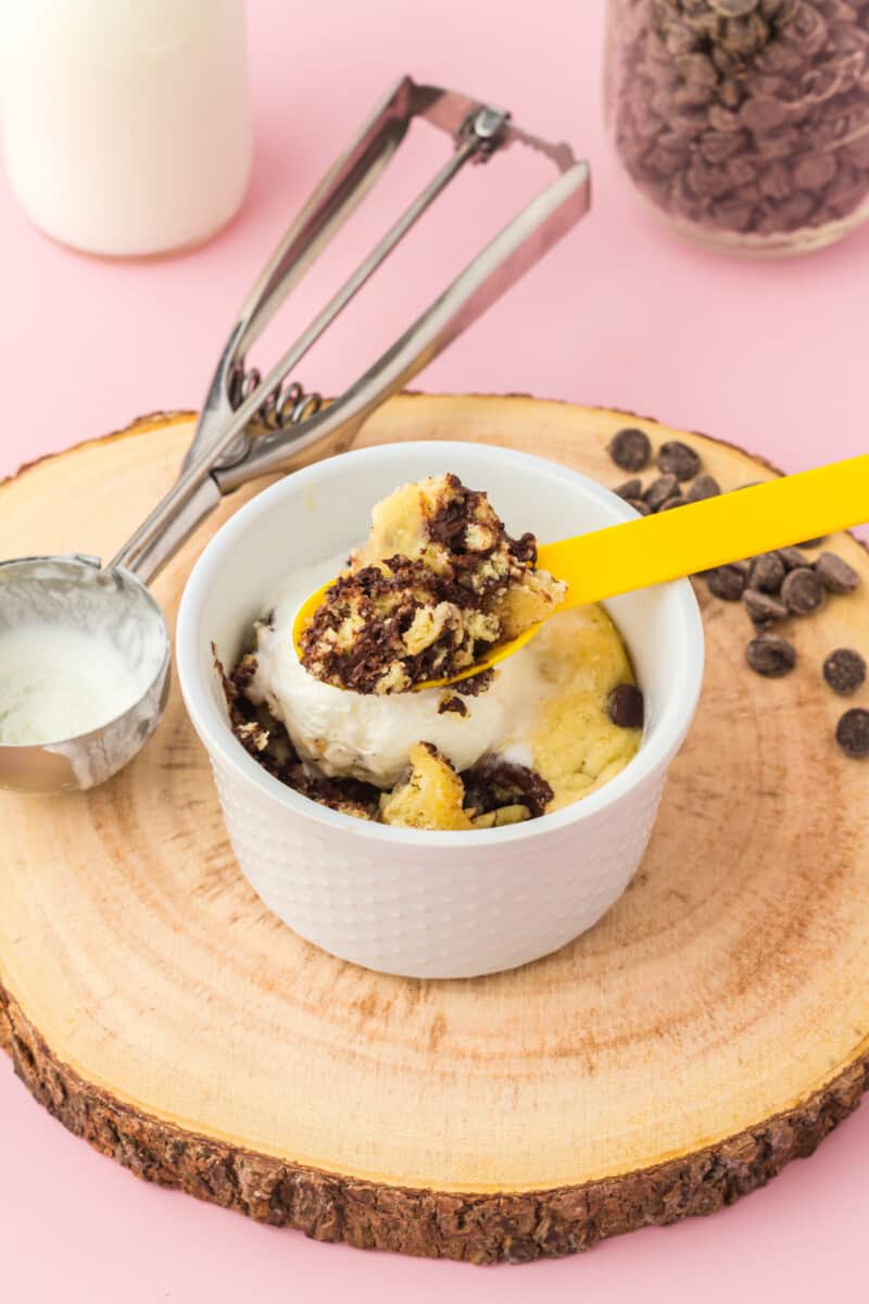 yellow spoon in chocolate chip cookie in a mug