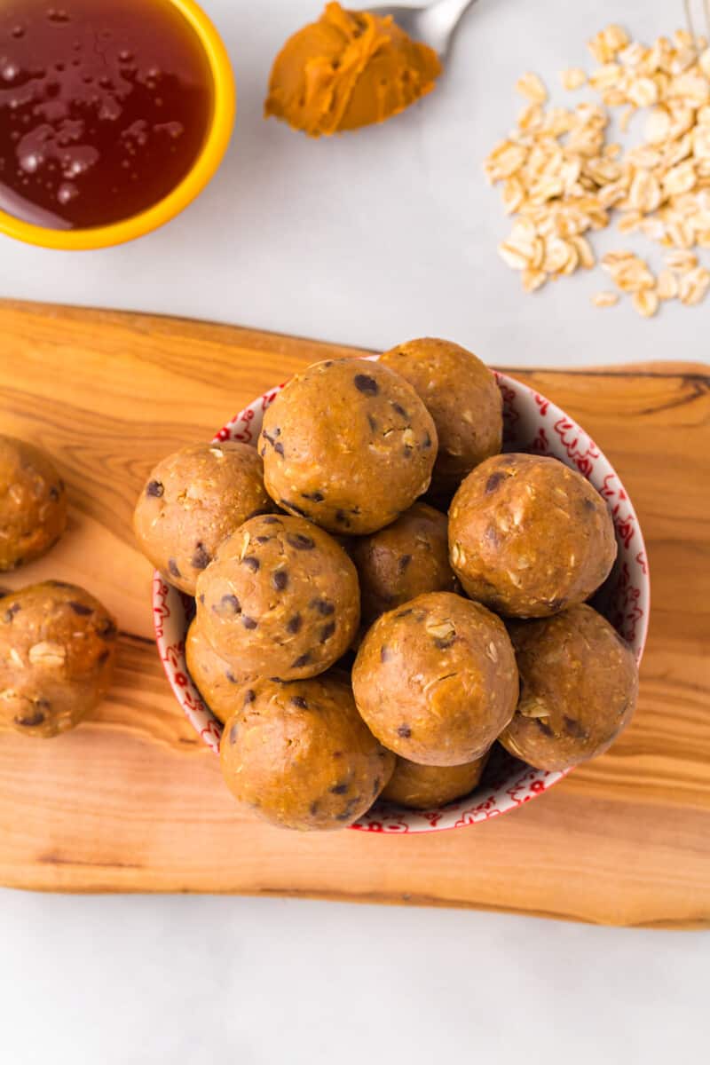 An overhead image of a bowl full of  peanut butter protein balls with chocolate chips.