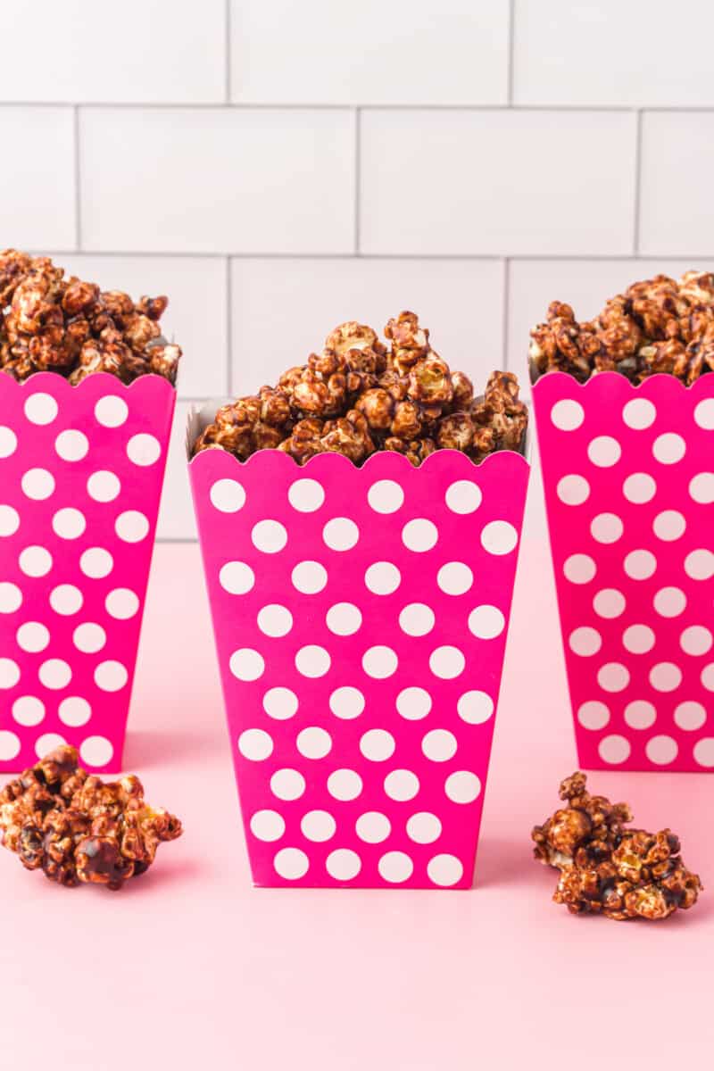 chocolate popcorn in pink and white containers