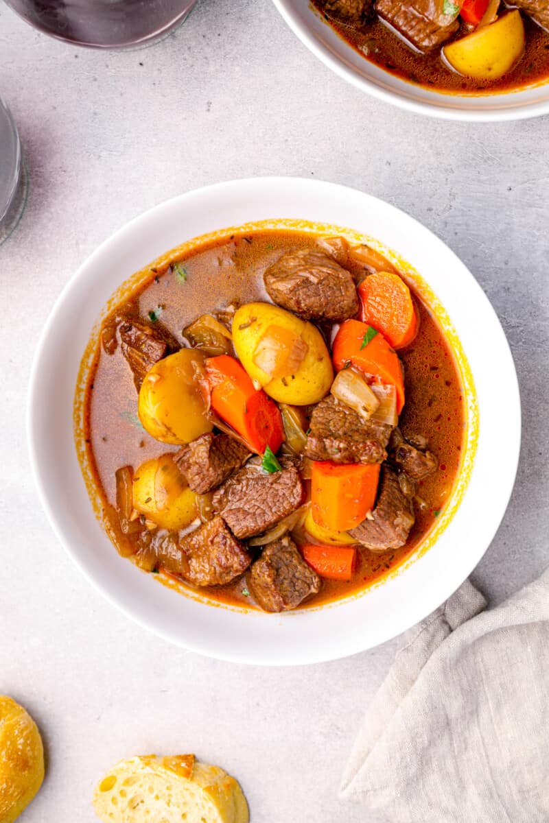 overhead image of a serving of beef stew in a white bowl