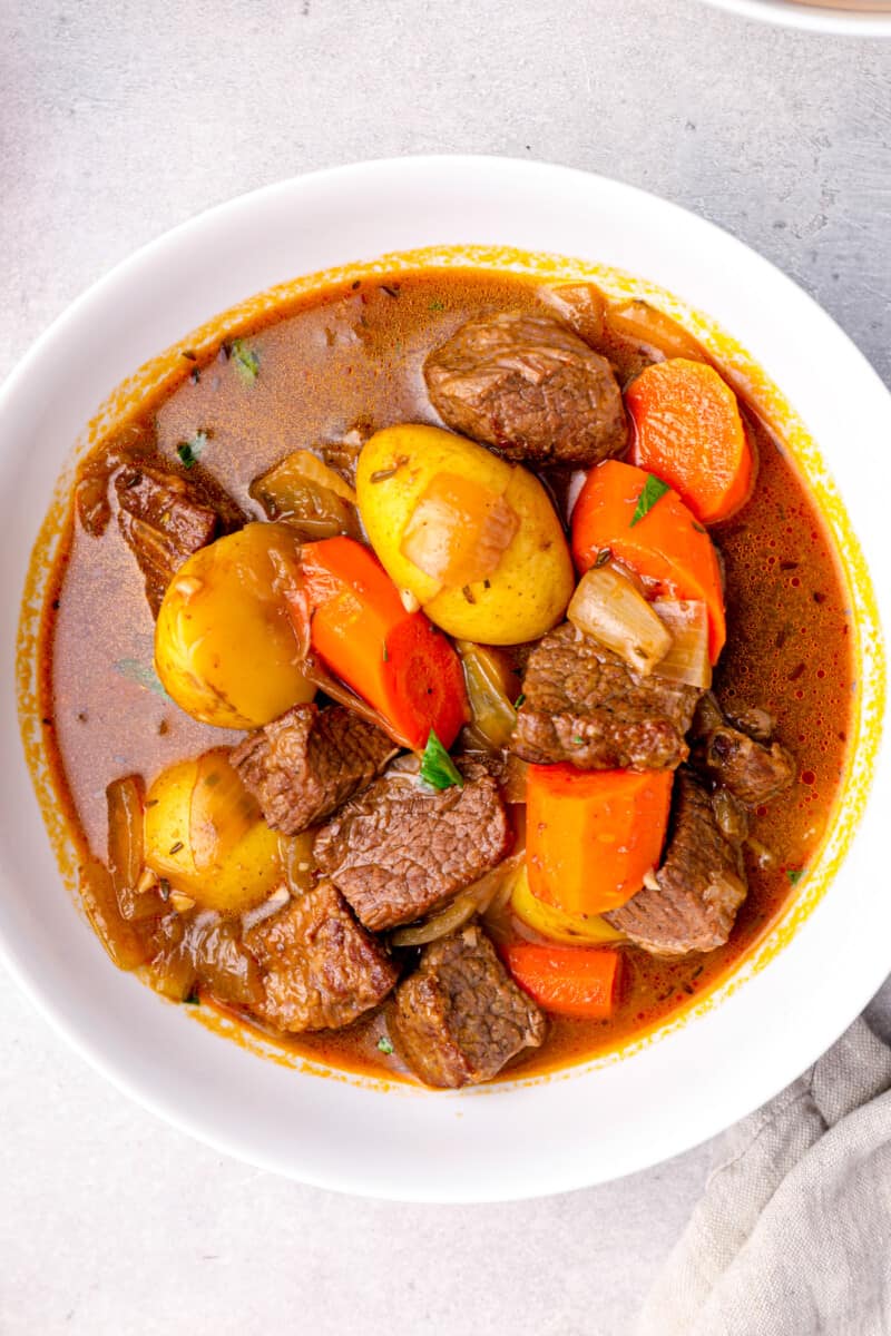 overhead image of a serving of beef stew in a white bowl