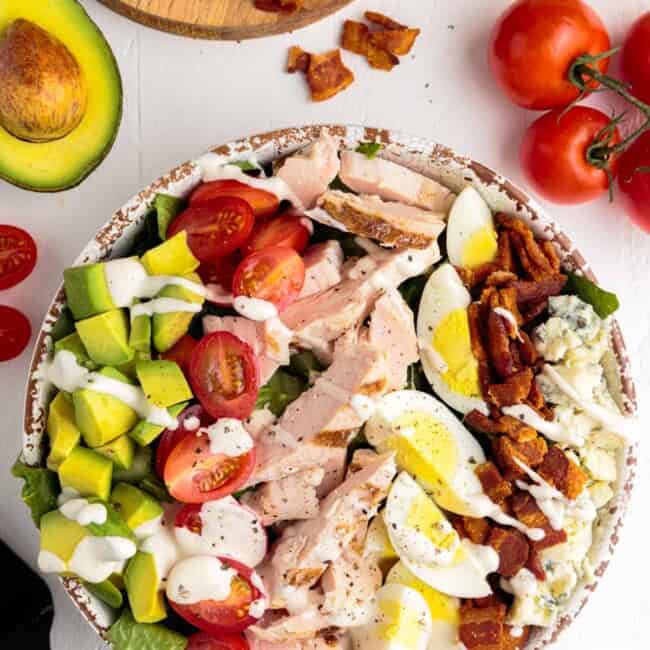 overhead image of cobb salad with dressing
